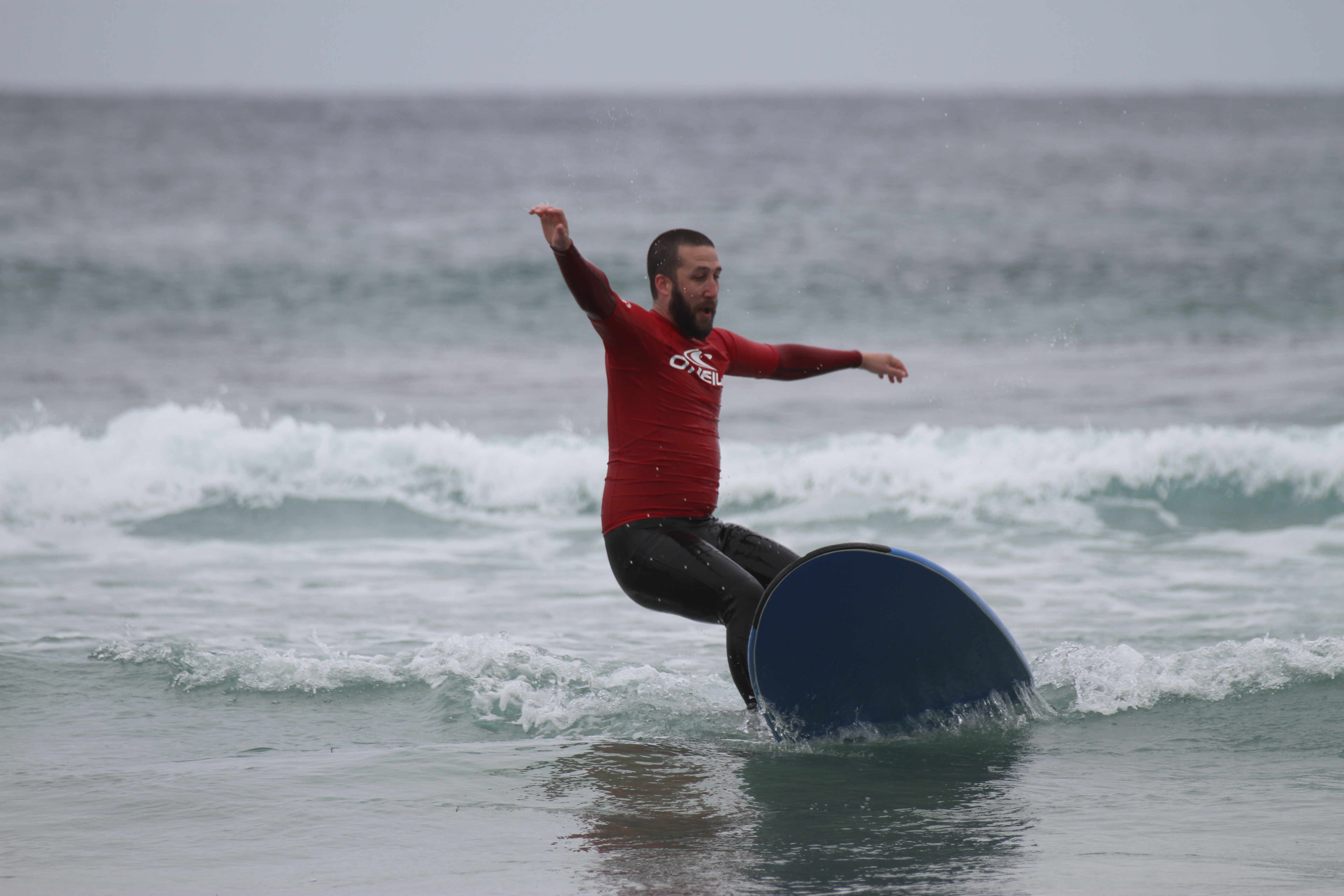 Sean falls off his surfboard